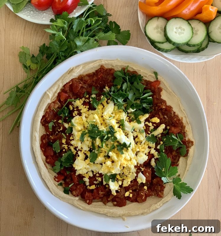 Hummus Shakshuka Snack Bowl with Veggies and Sweet Potato Chips via LizsHealthyTable.com 