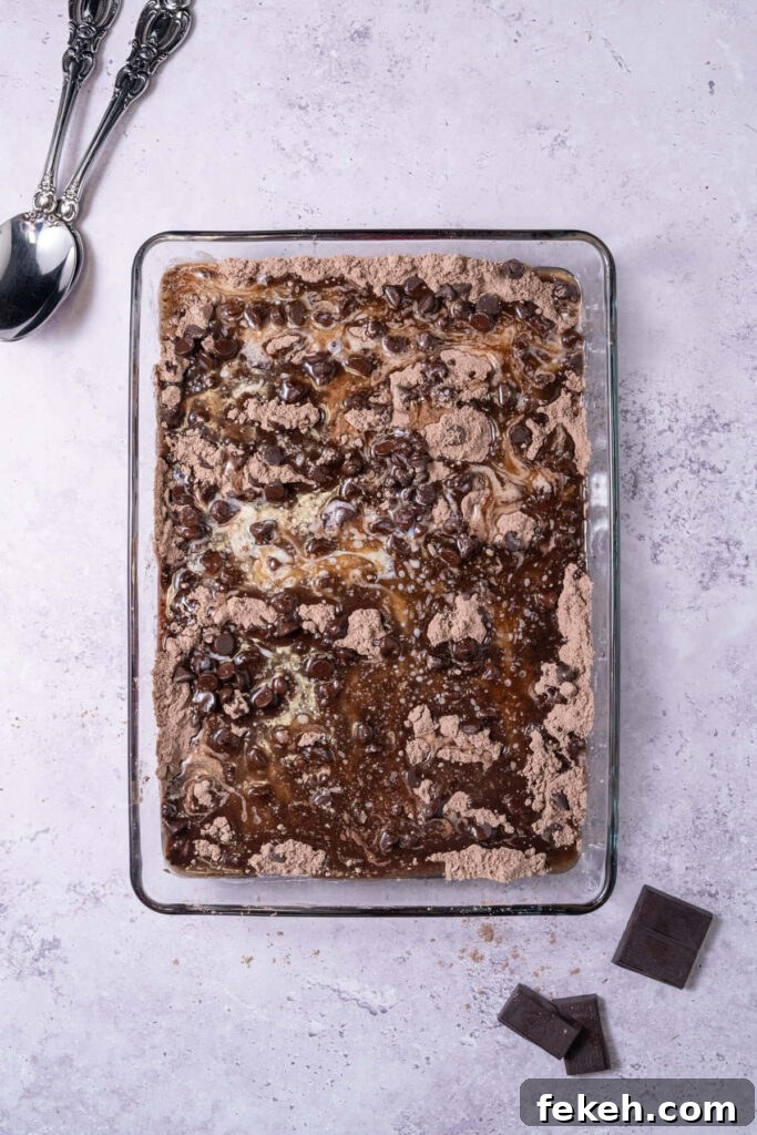 4-Ingredient Chocolate Cherry Dump Cake Recipe 6 Melted butter drizzled on top of chocolate cherry dump cake before baking in the oven.