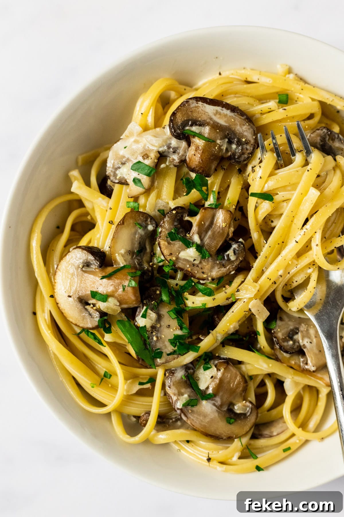 Creamy Garlic Mushroom Pasta Recipe: Rich, Silky Dinner Idea 2 A close up view of a bowl of creamy mushroom pasta.