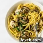 A close up view of a bowl of creamy mushroom pasta.