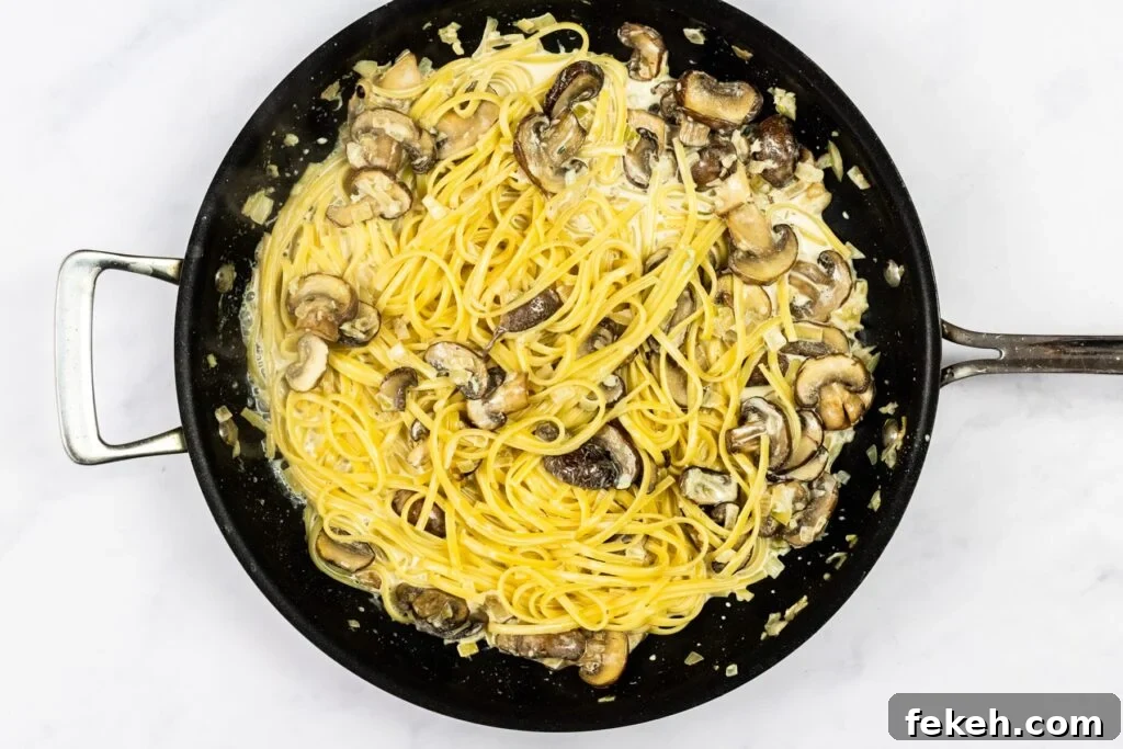 Creamy Garlic Mushroom Pasta Recipe: Rich, Silky Dinner Idea 8 Creamy garlic mushroom pasta cooking in a skillet.