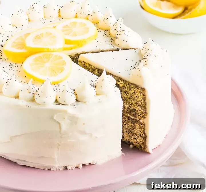 lemon poppy seed cake on a cake stand, sliced so you can see the inside of the cake