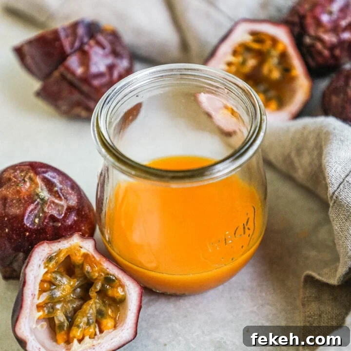 Homemade passion fruit puree in a glass jar surrounded by fresh passion fruit, used for cocktails, desserts, and more.