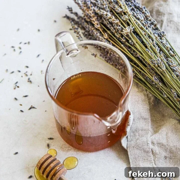 Honey lavender simple syrup in a glass carafe for lattes, tea, cocktails, and more.