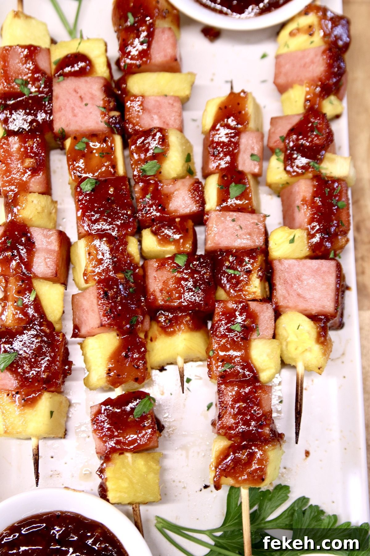 Easy pineapple kabobs with spam or ham and bbq sauce - cookout appetizer closeup of spam and pineapple kabobs topped with bbq sauce