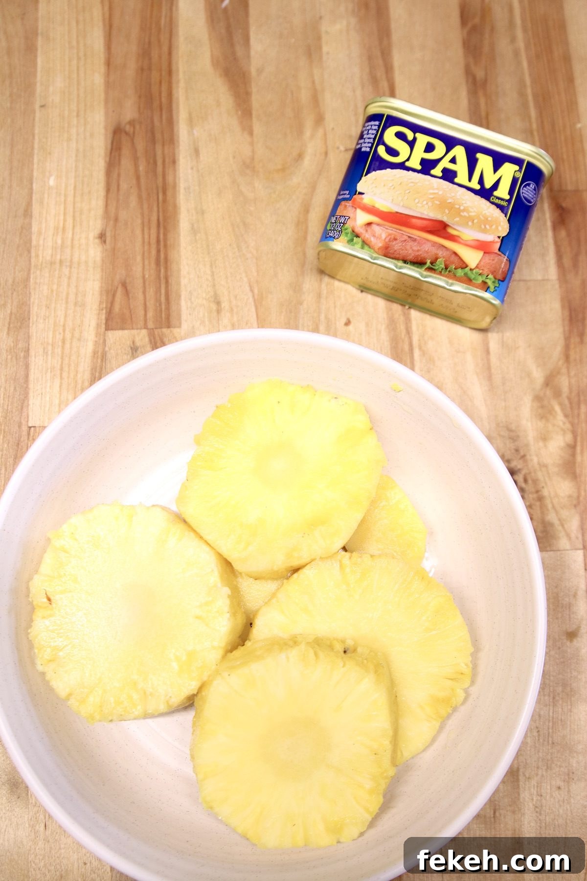 Grilled Spam and Pineapple Kabobs with Tangy BBQ Glaze 2 can of spam with fresh pineapple cut into rounds in a bowl