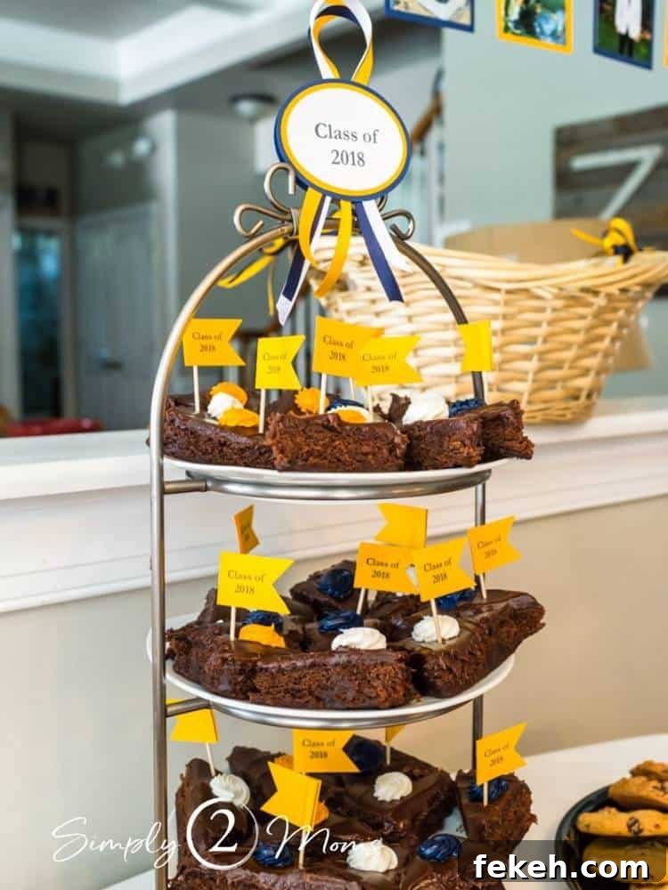 Tiered stand with decorated brownies and a label with Class of 2018 tied on top