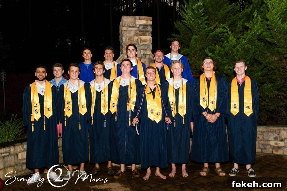Photo of a large friend group of high school guys in their graduation gowns