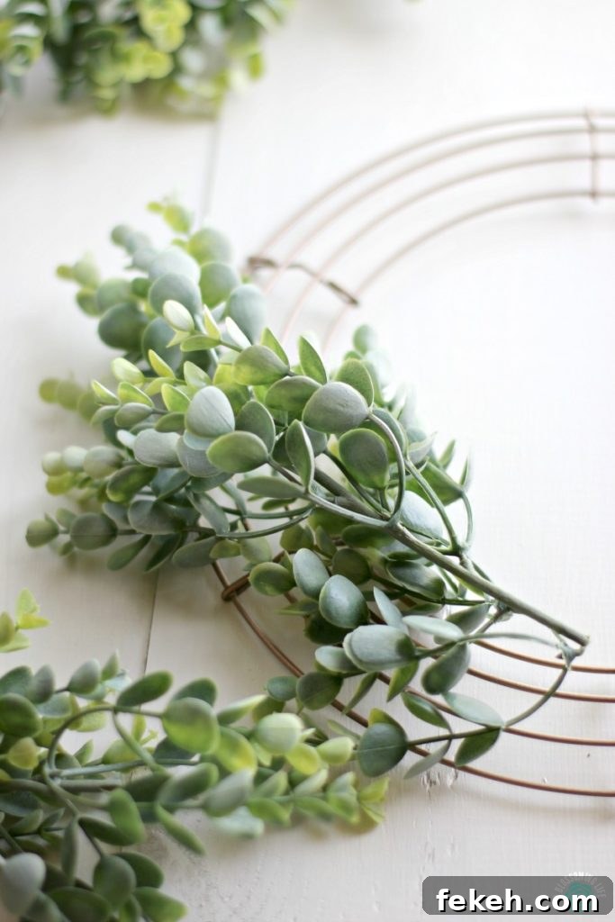 Attaching greenery to wreath