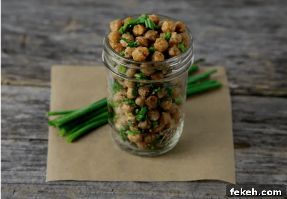 Cool Ranch Roasted Chickpeas in a jar next to some chives