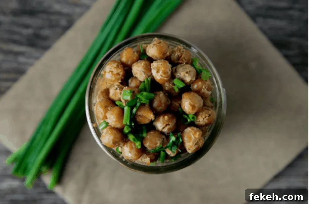 Cool Ranch Roasted Chickpeas in a jar next to some chives
