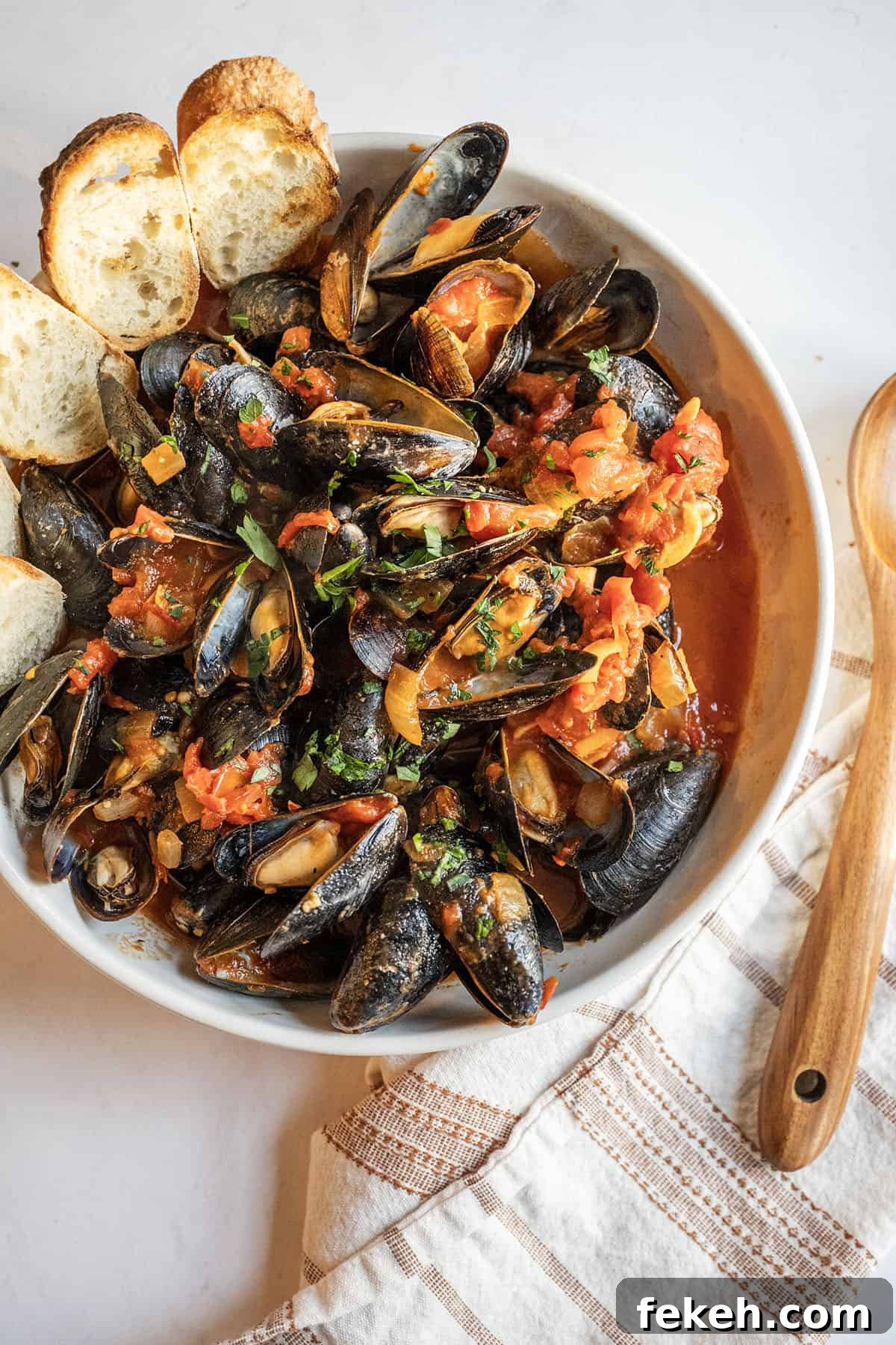 Spicy Mussels Fra Diavolo Recipe: Fiery Tomato & Garlic Stew 11 Mussels Fra Diavolo in a serving bowl with crostini.