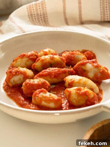 Stuffed calamari in tomato sauce on a plate.