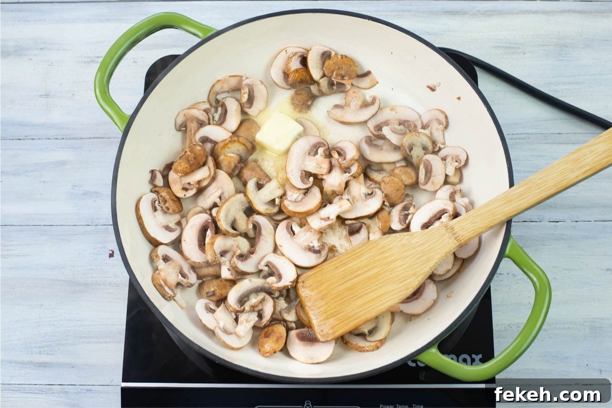 sautéing mushrooms with butter in a green enamel skillet.