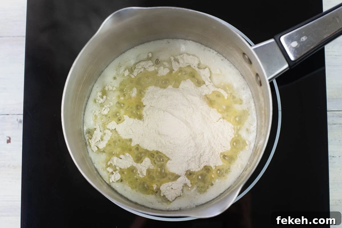 Mixing flour and melted butter in a sauce pan.