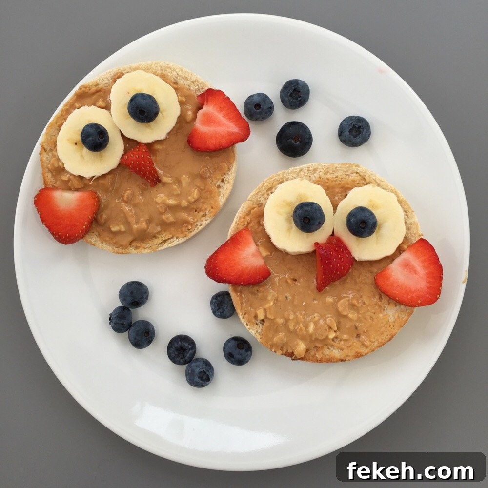 Colorful Berry Breakfast Bowl with Yogurt and Granola 3 white plate with toasted muffins topped with sliced bananas, strawberries and blueberries to create an owl face