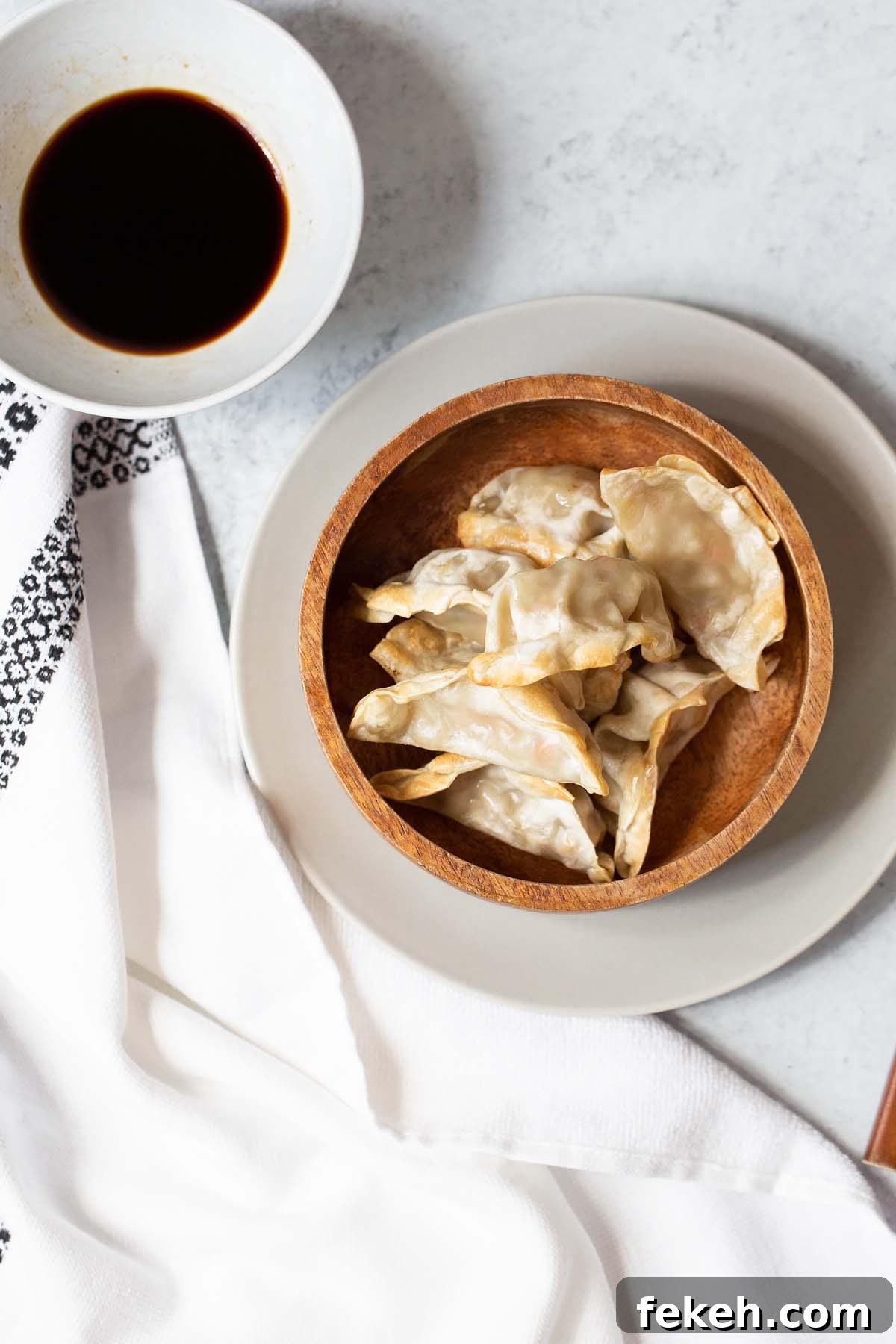Crispy Air Fryer Frozen Potstickers: Quick Cooking Guide 5 potstickers in a bowl with sauce on the side