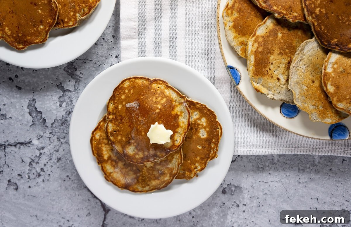 Freshly cooked buckwheat flour pancakes on a plate with a dab of butter.