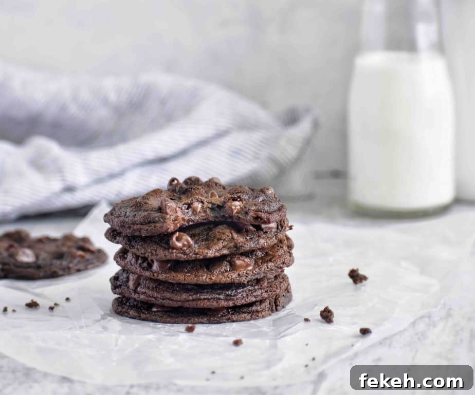 Bakery-Style Double Chocolate Cookies Recipe for Rich, Chewy Treats 3 stack of chocolate cookies with bite out of cookie
