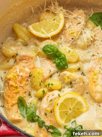 Cooked chicken gnocchi with lemon in a pan.