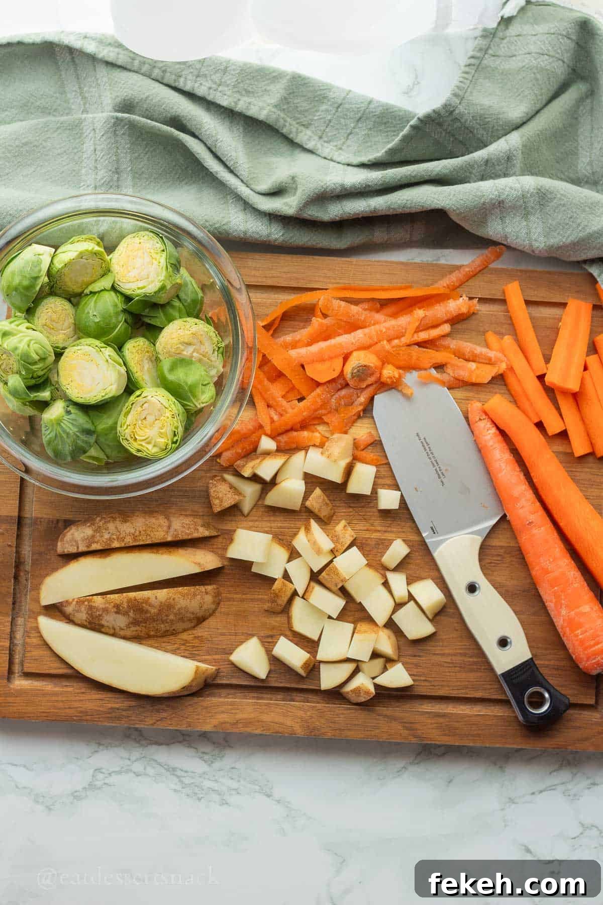 Sheet Pan Chicken Sausage with Roasted Veggies and Potatoes 4 Raw potatoes and carrots on cutting board with peelings and knife.