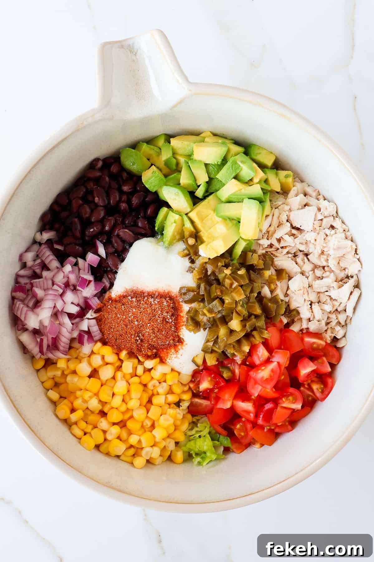 Crispy Chicken Salad Tostadas with Avocado and Lime 6 Ingredients in mixing bowl.