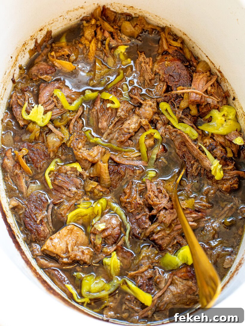 Slow Cooker Italian Beef Sandwiches with Tender Shredded Beef 2 Shredded italian beef in a slow cooker.