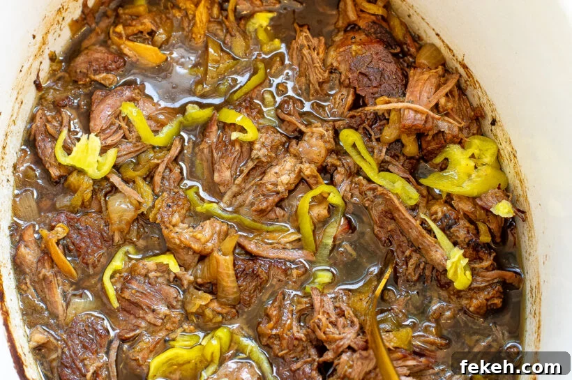 Slow Cooker Italian Beef Sandwiches with Tender Shredded Beef 7 Shredded italian beef in a slow cooker.
