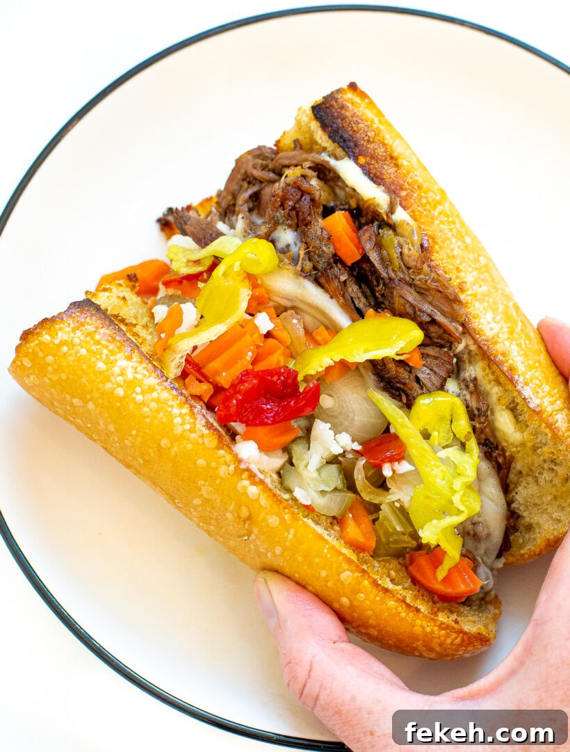 Slow Cooker Italian Beef Sandwiches with Tender Shredded Beef 8 A sandwich filled with italian beef and toppings.