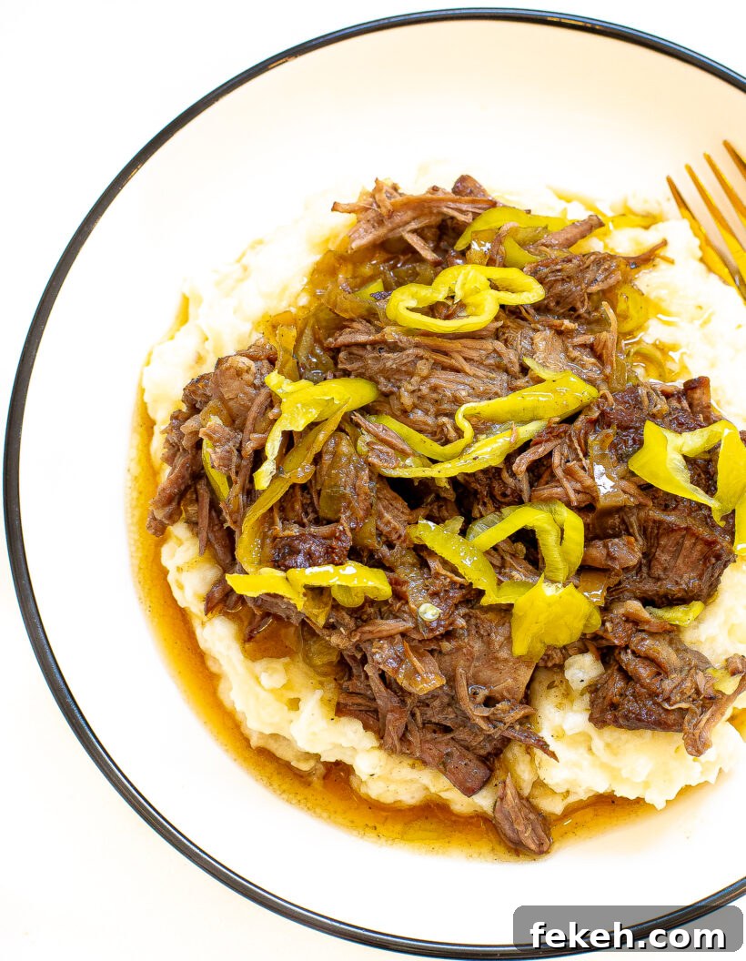 Slow Cooker Italian Beef Sandwiches with Tender Shredded Beef 9 Shredded italian beef on a bed of mashed potatoes.