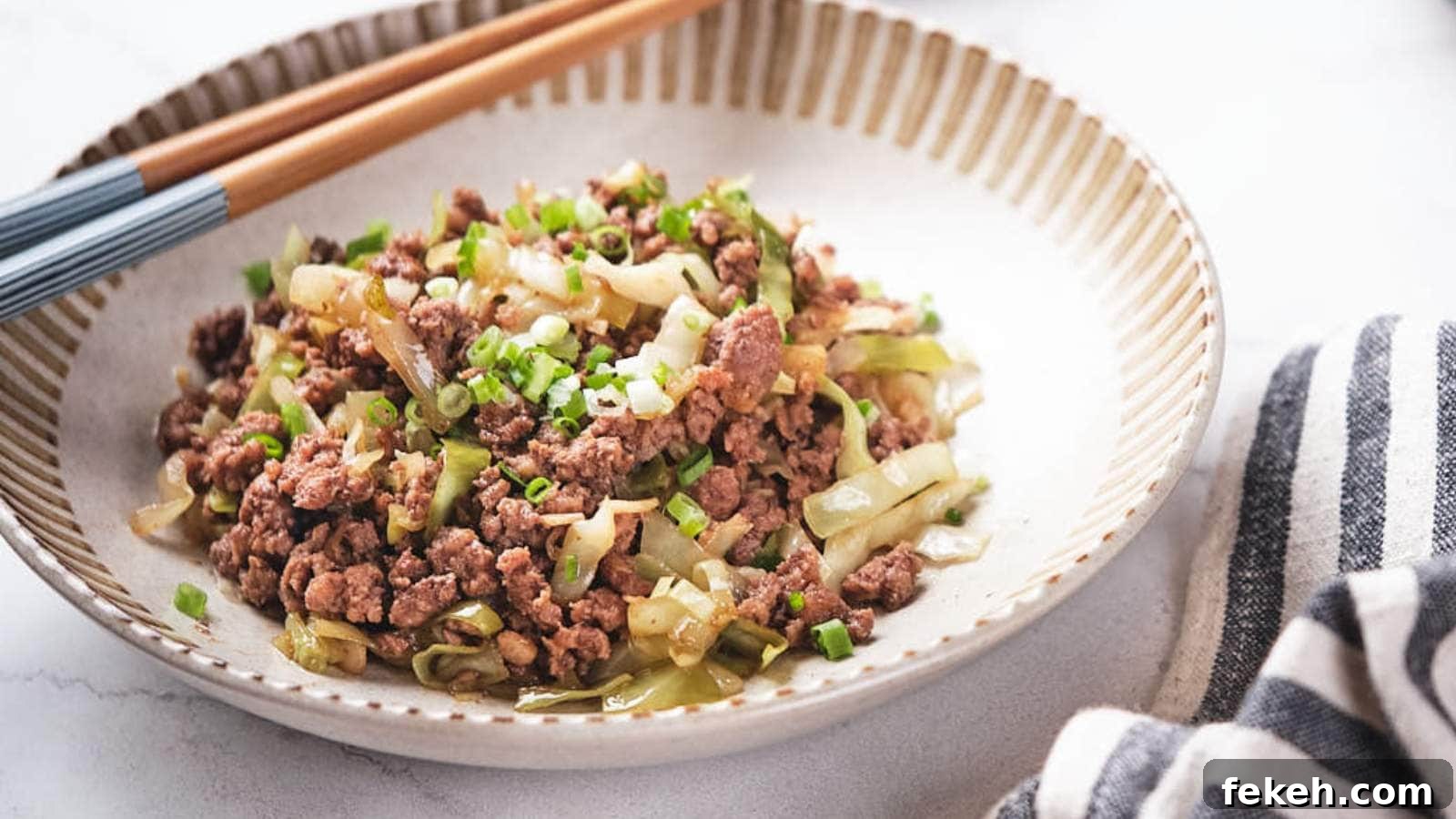 19 Kid-Approved Recipes Kids Beg For (Parents Love Them Too) 17 Ground beef and cabbage stir fry being scooped out from a skillet.