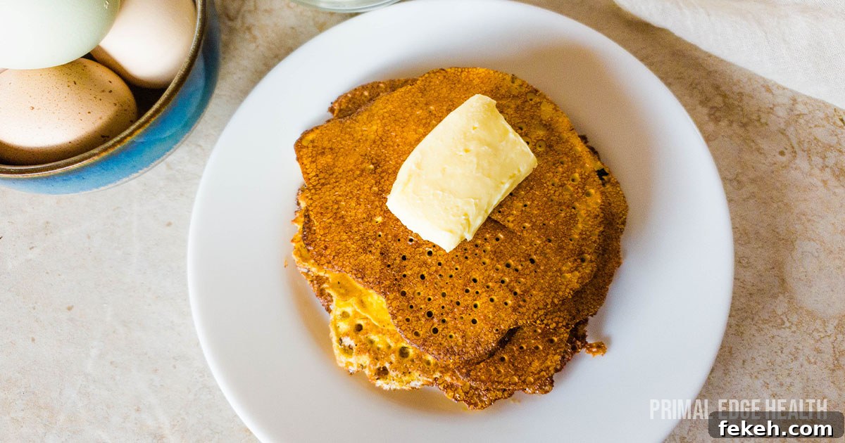 19 Kid-Approved Recipes Kids Beg For (Parents Love Them Too) 7 A stack of cream cheese pancakes on white plate with butter.