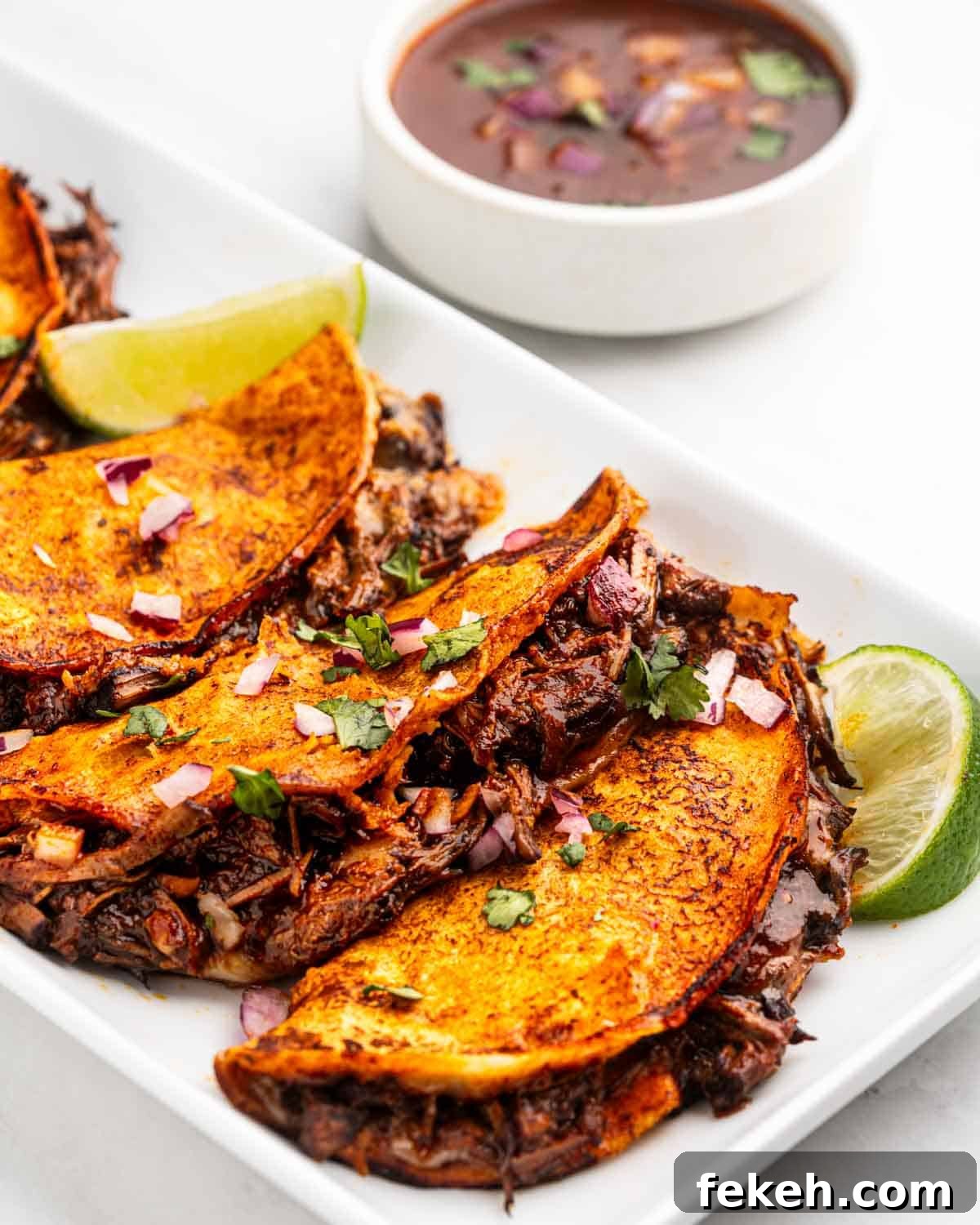 Authentic Quesabirria Tacos: How to Make Birria Tacos at Home 2 close up for birria taco and shredded meat.