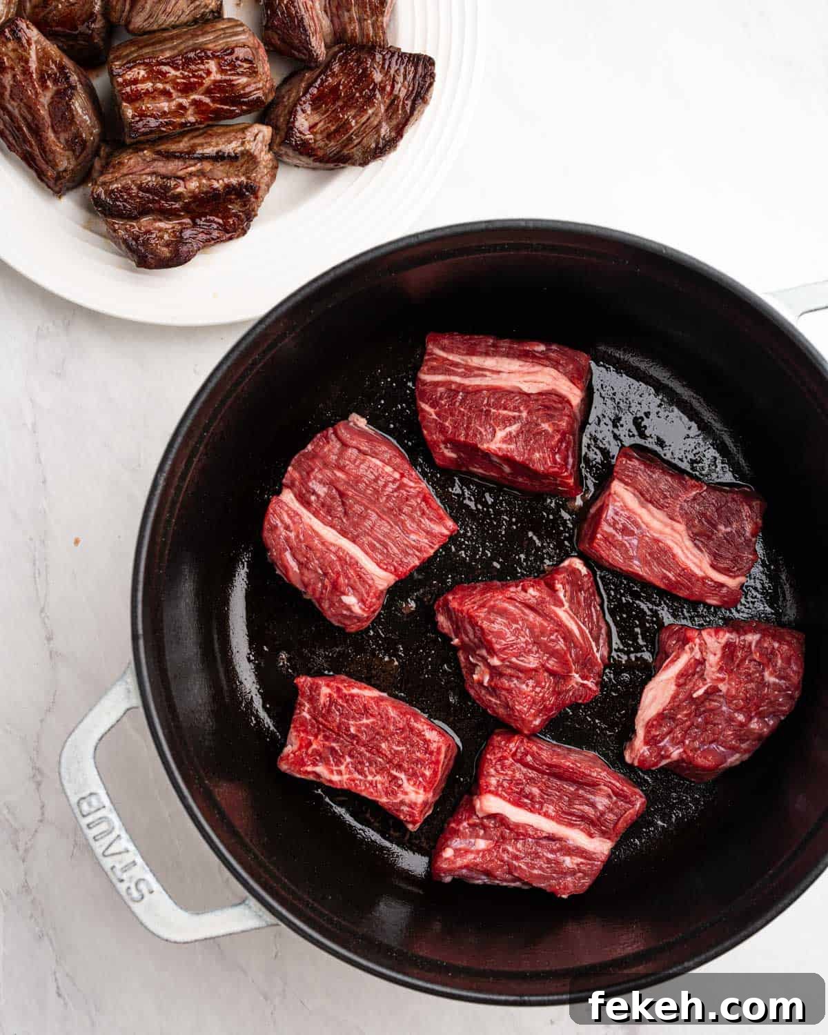Authentic Quesabirria Tacos: How to Make Birria Tacos at Home 7 Pan searing beef on all sides in pot.