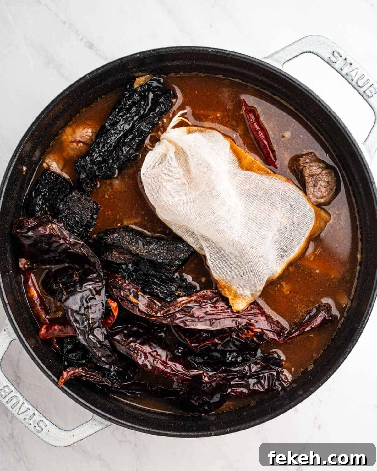 Authentic Quesabirria Tacos: How to Make Birria Tacos at Home 8 Pot of broth, dried chilies, spices, and beef.