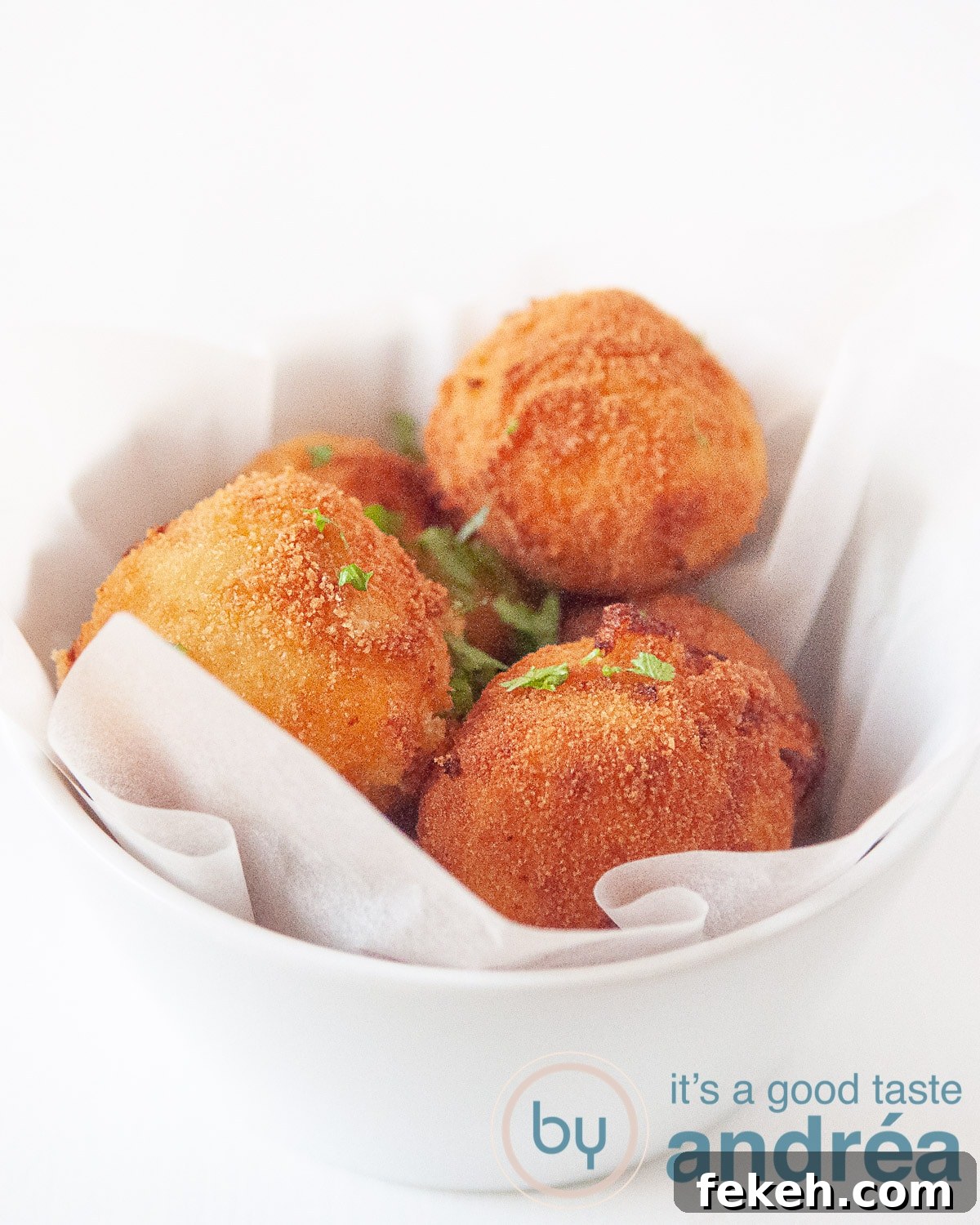 four cheese bitterballen in a white bowl