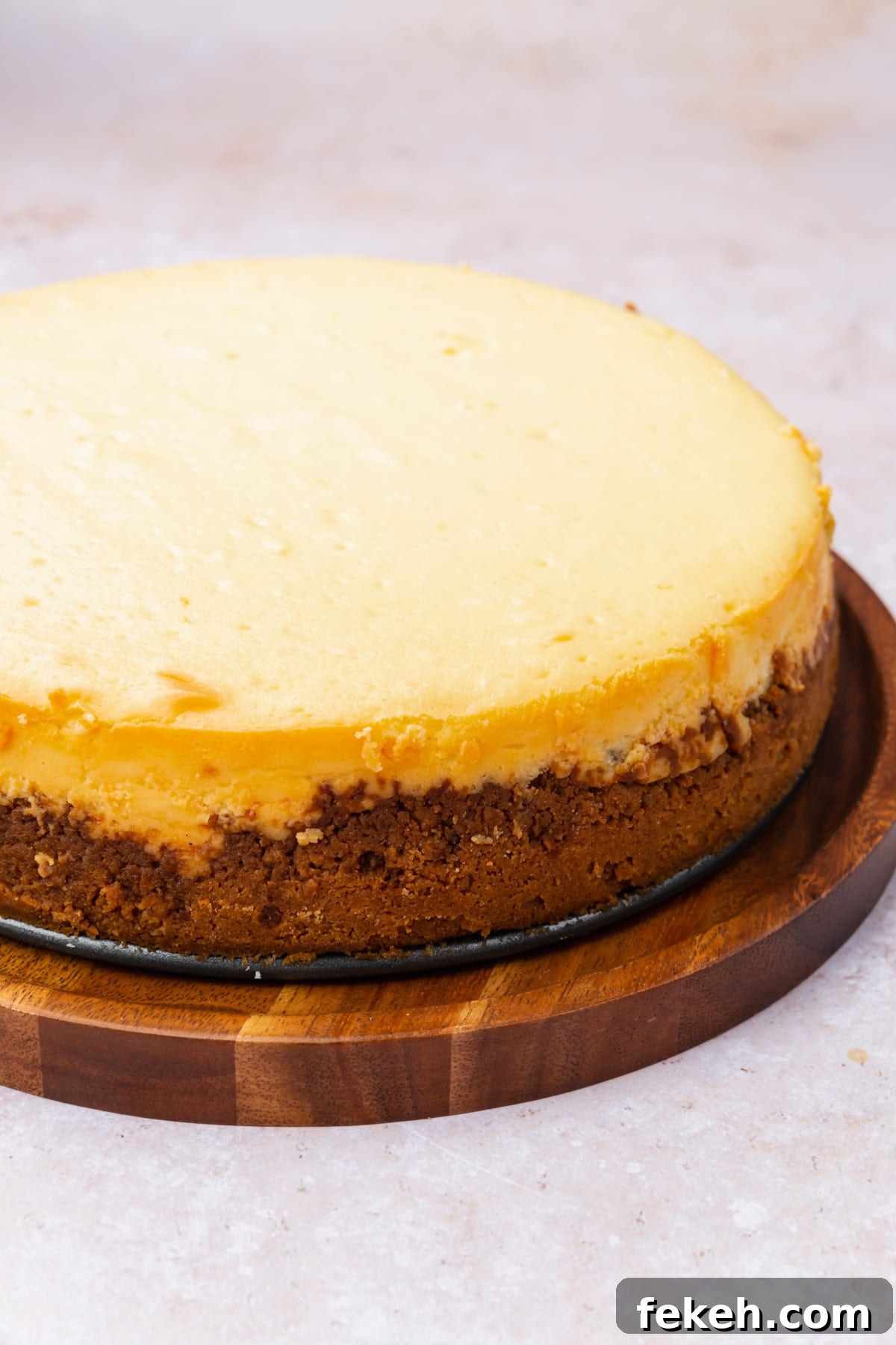 Gluten-Free Graham Cracker Pie Crust Recipe 4 A plain gluten-free cheesecake on a wood board.