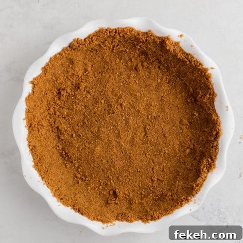 Gluten-Free Graham Cracker Pie Crust Recipe 6 A pie tin with gluten-free graham cracker crust in it.