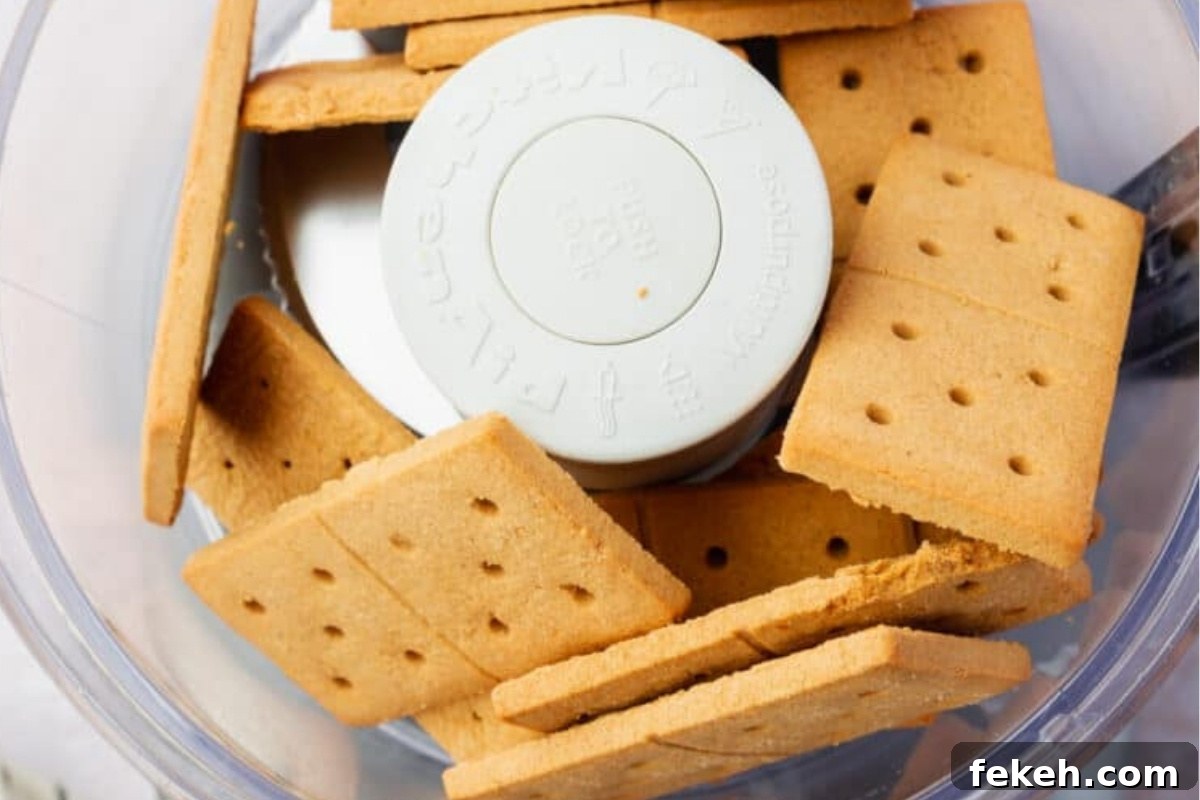 Gluten-Free Graham Cracker Pie Crust Recipe 7 Graham crackers in a food processor ready to be crushed.