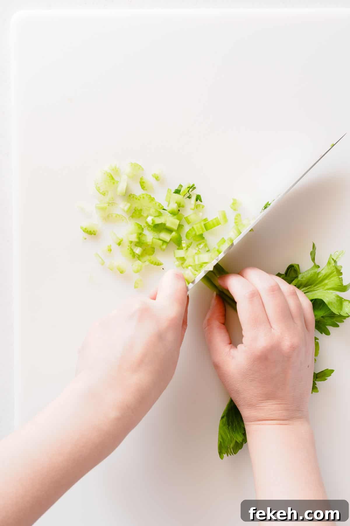 Greek Yogurt Tuna Salad Recipe Without Mayo — High-Protein Lunch 4 celery being chopped on cutting board