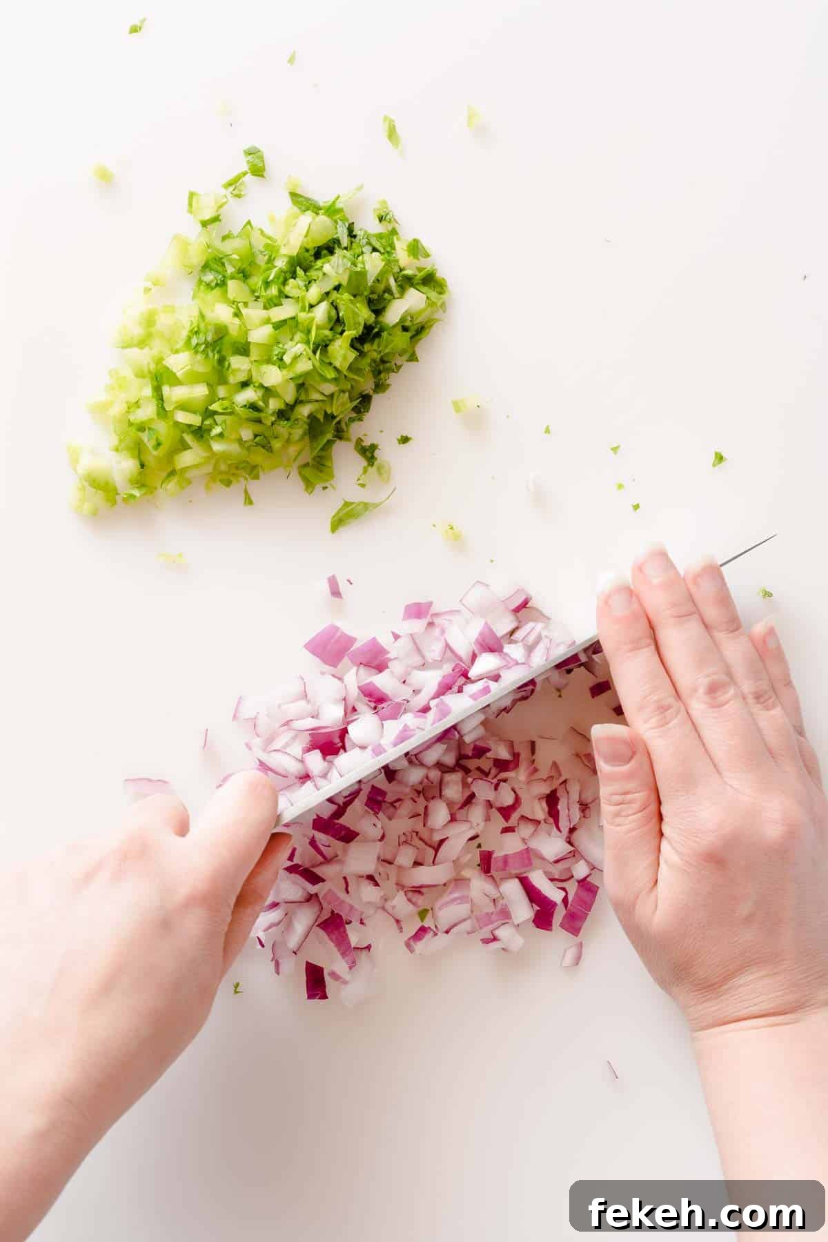 Greek Yogurt Tuna Salad Recipe Without Mayo — High-Protein Lunch 5 red onion being chopped on cutting board with chopped celery on the side