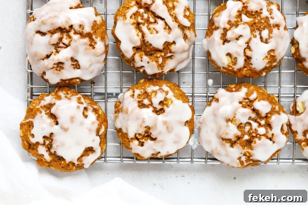 Gluten-Free Pumpkin Snickerdoodle Cookies for Fall Baking 9 vanilla glazed gluten-free pumpkin oatmeal cookies on a wire rack
