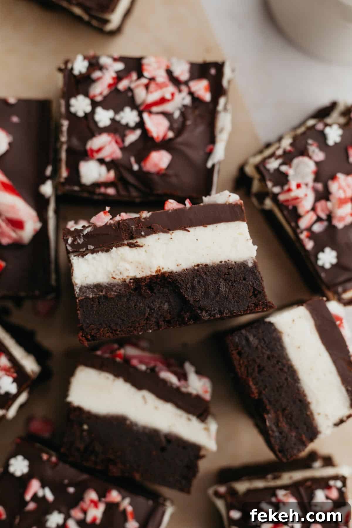 Peppermint Bark Brownies Recipe: Fudgy Chocolate with Candy Cane Topping 2 Layered peppermint brownies on parchment paper.