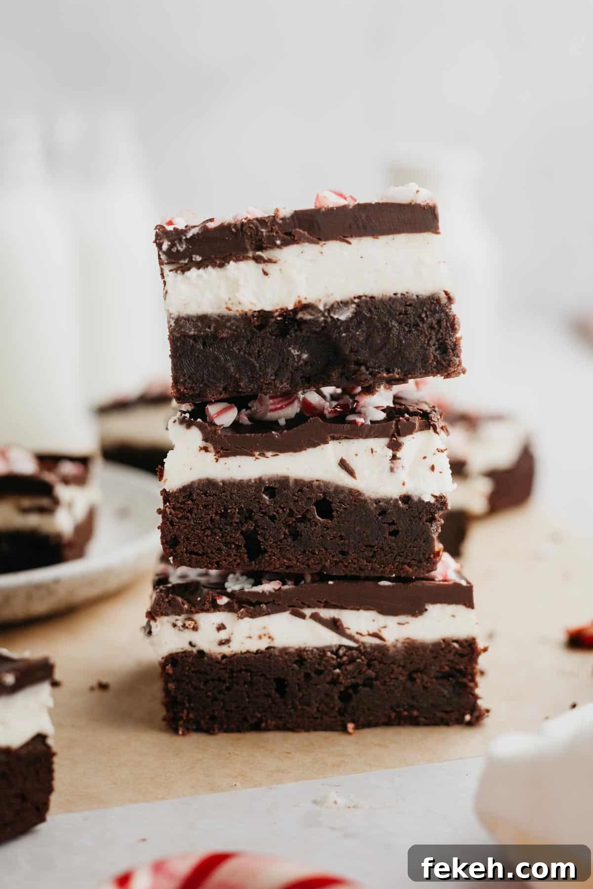 Peppermint Bark Brownies Recipe: Fudgy Chocolate with Candy Cane Topping 9 A stack of three peppermint bark brownies.