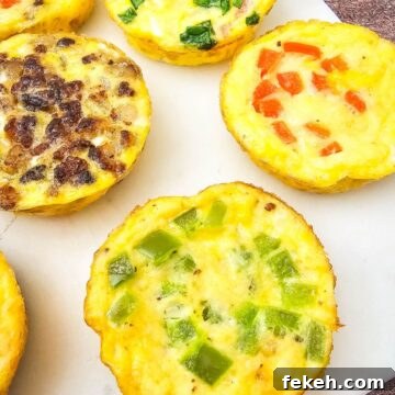 Dairy-Free Gluten-Free Egg Bites Recipe for Meal Prep 13 Mini dairy-free egg bites with bell peppers in them on a white plate.