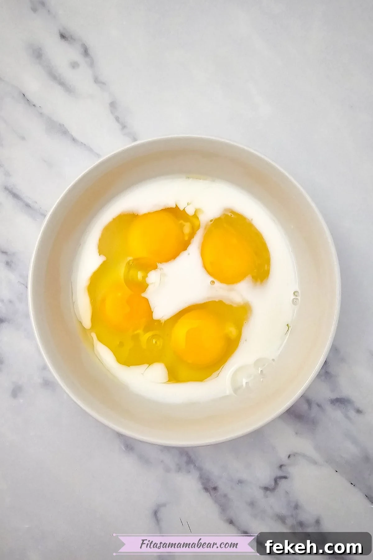Dairy-Free Gluten-Free Egg Bites Recipe for Meal Prep 5 Eggs and dairy-free milk in a white bowl.