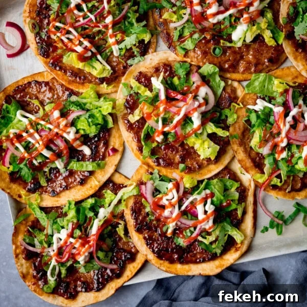 Grilled Chicken Souvlaki Recipe: Tender Mediterranean Skewers 9 Overhead image of pork smash tacos topped with shredded lettuce and pickled onions