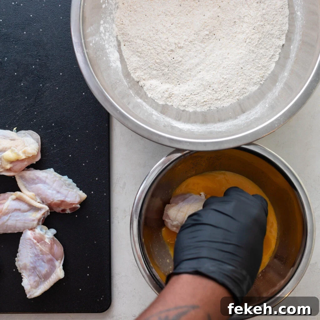 Crispy Southern Fried Chicken Wings Recipe for Perfect Crunch 5 dipping chicken wings into egg wash