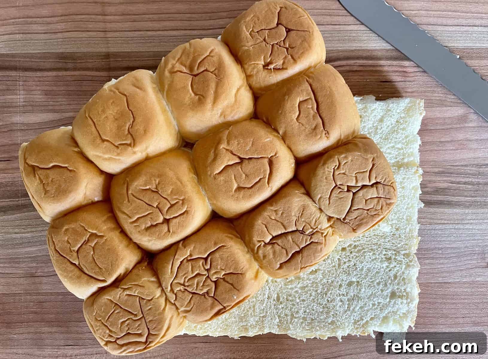 Antipasto Sliders on King's Hawaiian Rolls: Italian Sandwich Recipe 4 King's Hawaiian Rolls sliced in half lengthwise on a wood cutting board.
