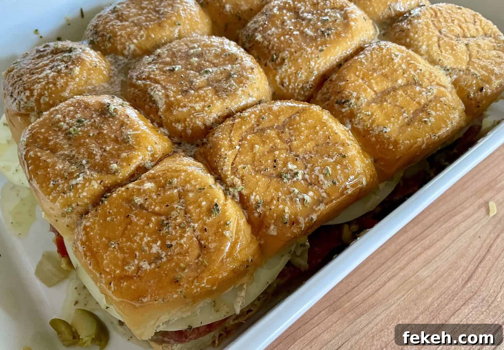 Antipasto Sliders on King's Hawaiian Rolls: Italian Sandwich Recipe 8 slide view of sandwiches brushed with a seasoned butter topping.